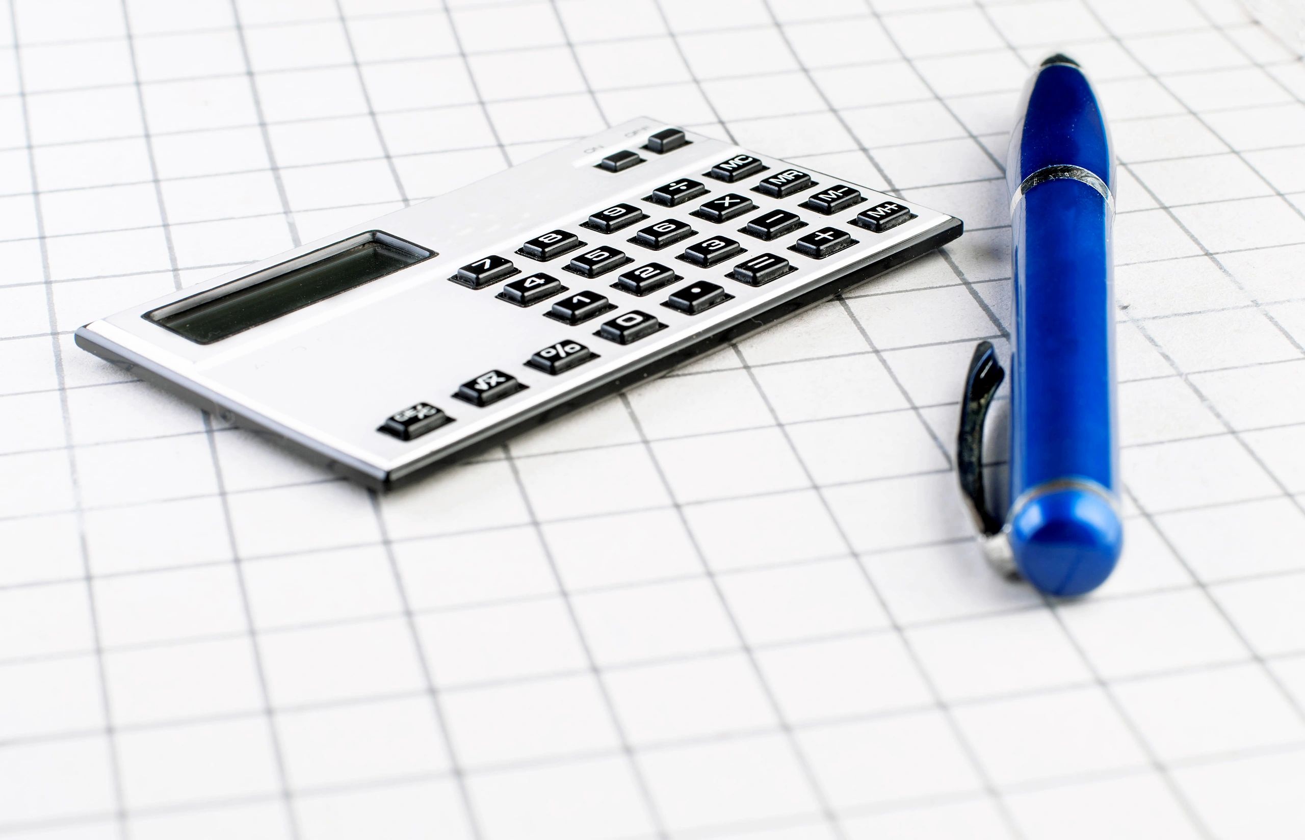 Calculator and pen used for financial statement preparation