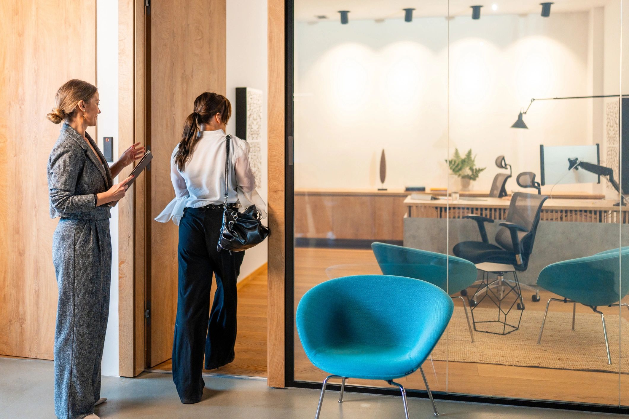 Professional advisor welcoming client into office meeting room